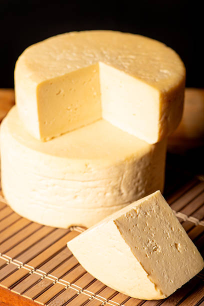 istock Semi-cured cheese made in Minas Gerais, Brazil, on a rustic surface and dark background, selective focus. 2229612978