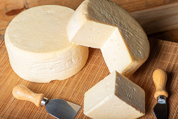 istock Semi-cured cheese made in Minas Gerais, Brazil, on a rustic surface and dark background, selective focus. 2229613000