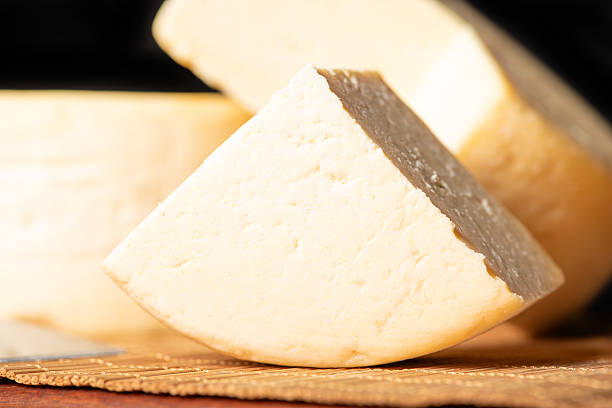 istock Semi-cured cheese made in Minas Gerais, Brazil, on a rustic surface and dark background, selective focus. 2229613082