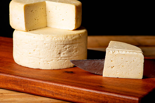 istock Semi-cured cheese made in Minas Gerais, Brazil, on a rustic surface and dark background, selective focus. 2229613133