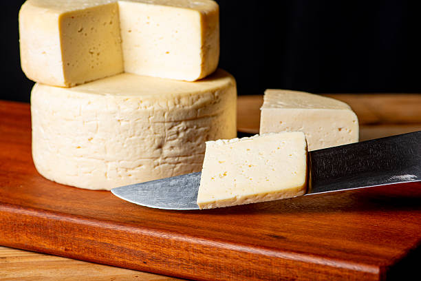 istock Semi-cured cheese made in Minas Gerais, Brazil, on a rustic surface and dark background, selective focus. 2229613204