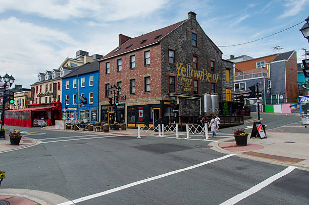 Downtown streets bustling with bars and shops, where colorful storefronts and lively crowds capture the city’s vibrant social scene in Newfoundland.