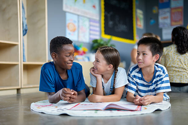 istock Smiling Children Collaborating on Shared Project in a Colorful Classroom Setting 2229620440