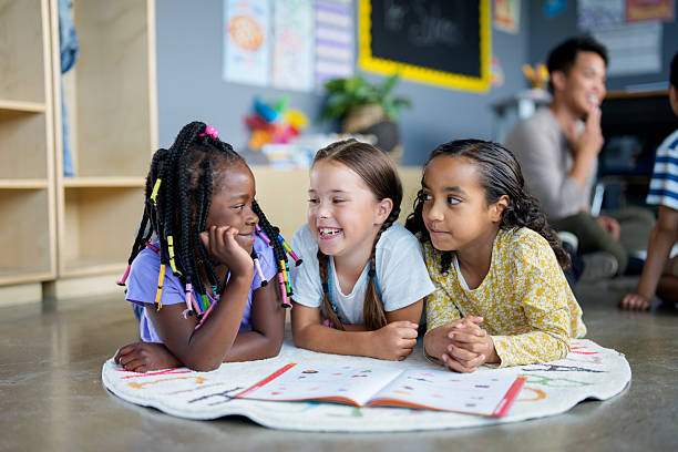 istock Three Diverse Kids Bonding During School Reading Activity in Vibrant Classroom Setting 2229620567
