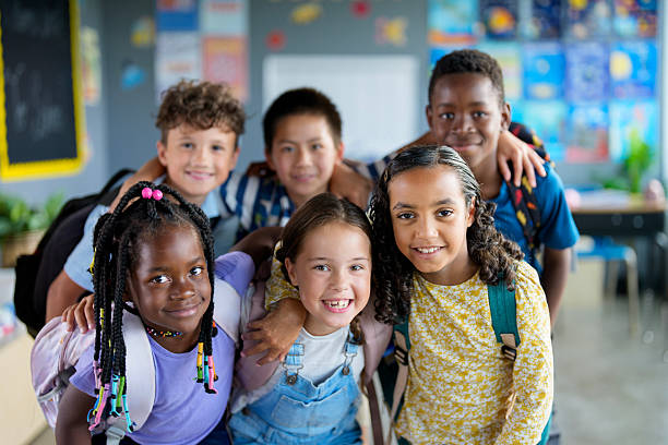 istock Group of Diverse School Kids Smiling Happily in Classroom Setting 2229620854