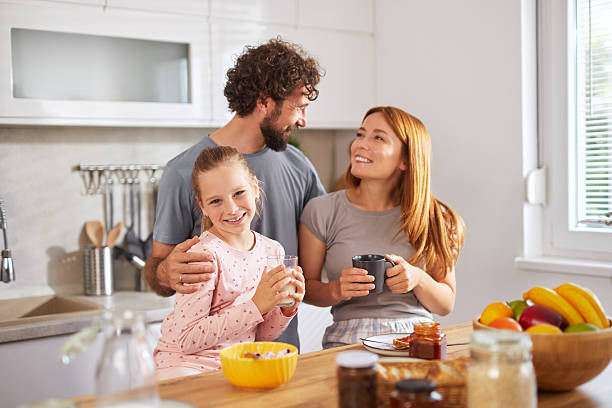 istock Happy family enjoying breakfast together in modern kitchen 2229621699