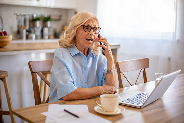 istock Senior woman working from home having phone call problems 2229622441