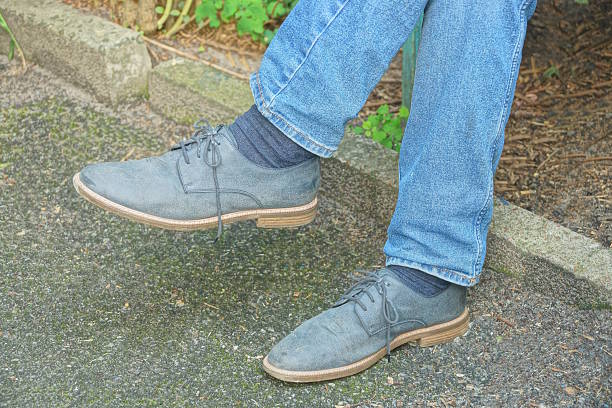 istock two blue suede boots on legs in jeans on gray ground 2229626533