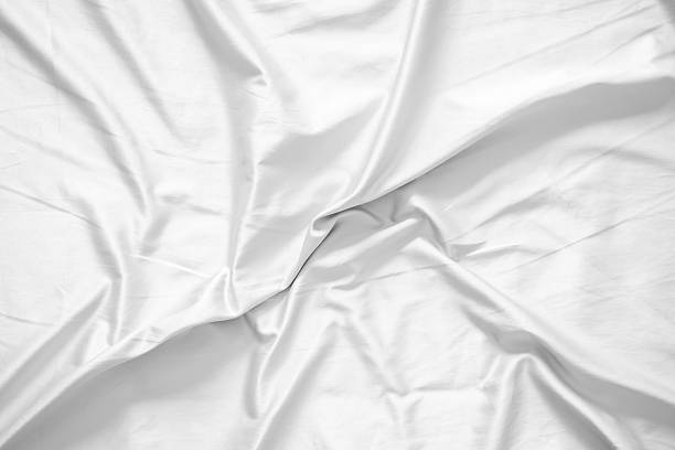istock Abstract white wrinkled bedding sheet fabric texture background 2229628123