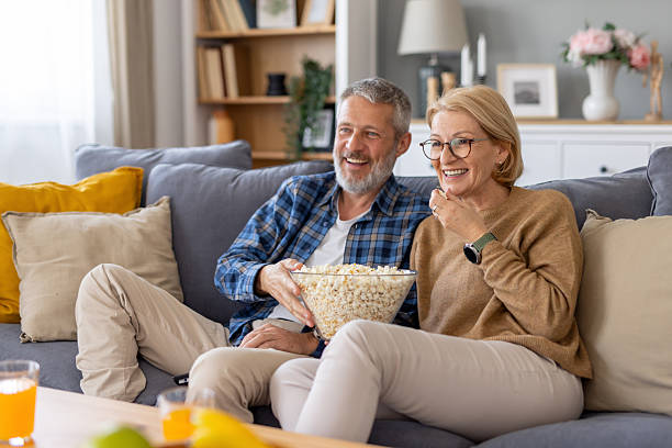 istock Couple Enjoying a Cozy Night with Popcorn and Smiles 2229628738