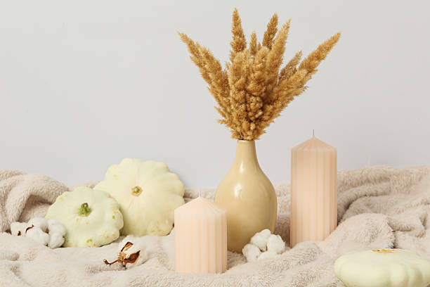 istock Candles, bouquet and zucchini on beige background 2229640256