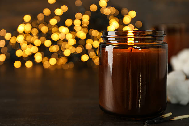 istock Candle on wooden table on dark background, space for text 2229640698