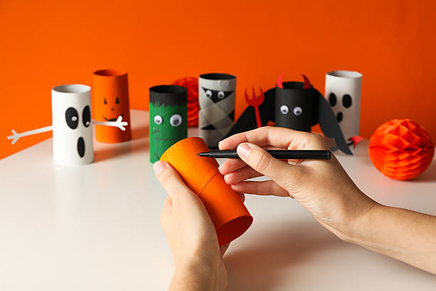 istock Paper Halloween mockups and female hands on orange background 2229642021