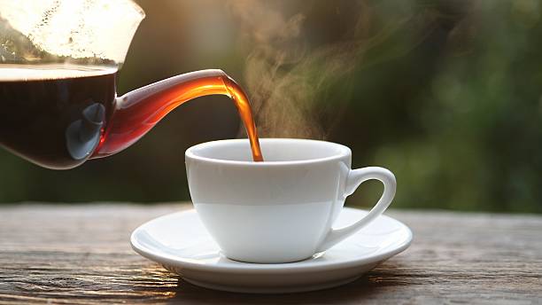 istock Hot coffee being poured into a white cup with steam rising, symbolizing warmth, energy, and relaxation. Perfect for cafe, breakfast, beverage, or morning lifestyle, Hot coffee concepts 2229647838
