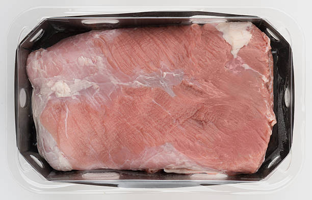 Fresh pork in plastic box top view isolated nature background with clipping path