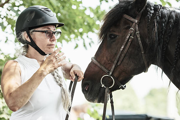 istock Mature woman getting ready for a horse ride 2229650251