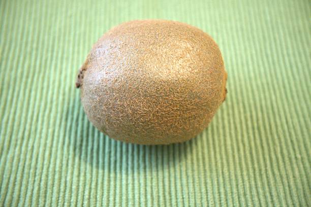 istock Whole Kiwi on Green Background - Close-Up with Copy Space 2229665723