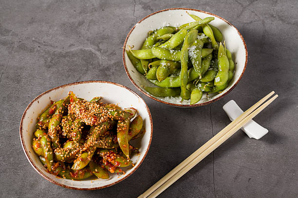 Spicy and salted edamame beans served in ceramic bowls
