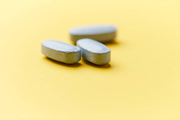 istock Multivitamin tablets on bright paper background. Close up. Copy space. 2229665831