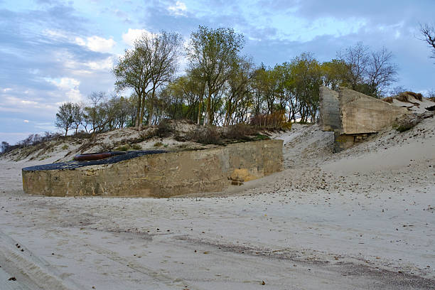 Old abandoned defensive bunker sandy shore Baltic Sea
