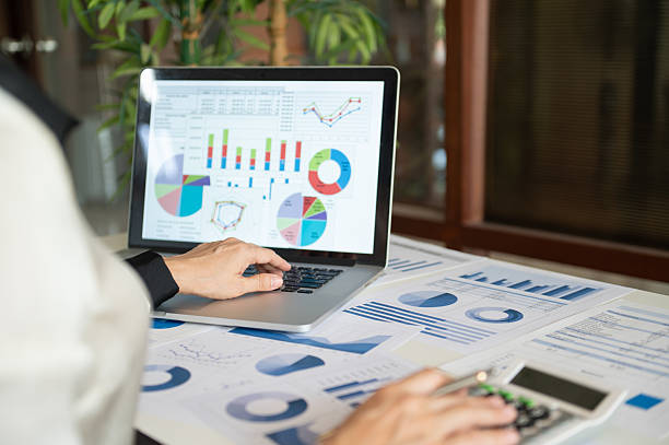 istock accountant using calcualtor with review accounts report and using digital accounting program software on computer for working accounting standards system at office. 2229666653