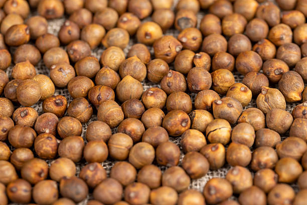 istock Roasted chickpeas are scattered on the table before cooking, fried but not boiled chickpeas are on the table with a tablecloth. 2229666827