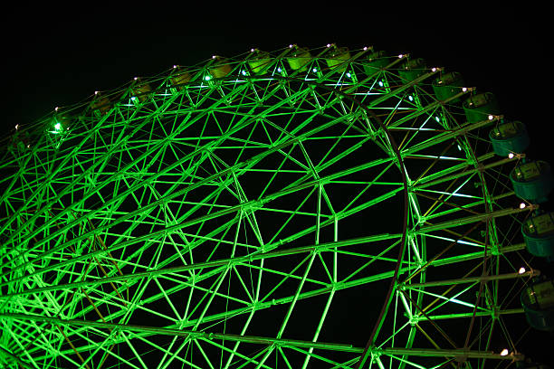 istock Illuminated green Ferris wheel against dark night sky 2229667091