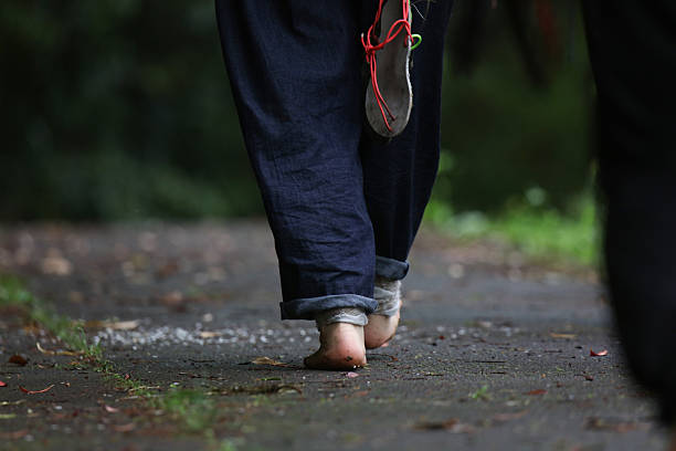 Image of a woman walking barefoot
