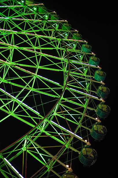 istock Illuminated green Ferris wheel against dark night sky 2229667765