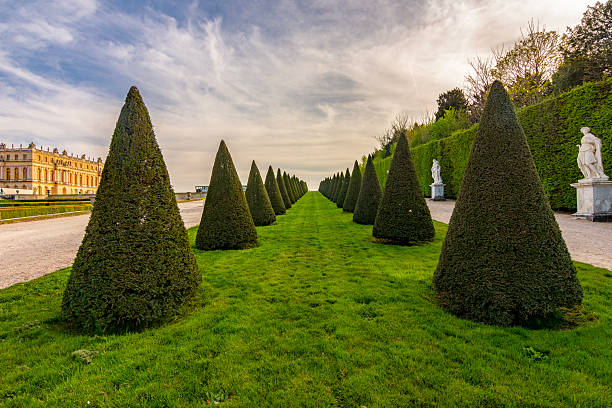 Paris, France - May, 2022:  Gardens of the famous Palace of Versailles. whole site have unique fountains, ponds, lake and landscapes built in 17th c.