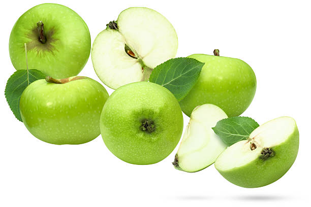 istock Fresh green apples whole, cut in half and sliced with leaves. 2229668604