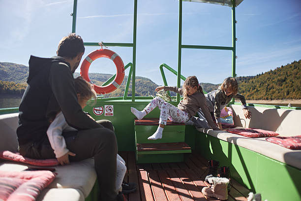 Young family having a boat trip. Single father with children.