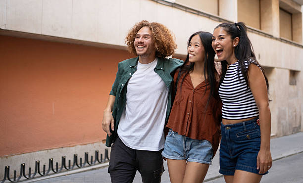 istock Three young adults walking down the street, having fun together 2229670024