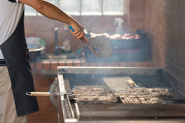 istock Chef grilling meat on barbecue with smoke in restaurant kitchen 2229670464