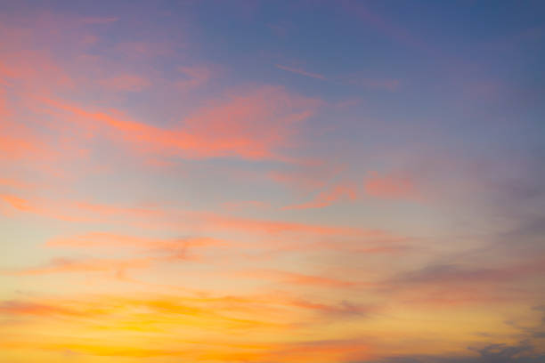 istock Clouds and orange sky in the morning background,Dusk,Pink and red sunlight and Dramatic storm clouds on Twilight sky, Landscape horizon Golden sky nature Summer Background , Sunset Sky Clouds in the Evening with colorful Orange, Yellow. 2229672585
