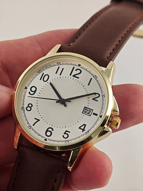 istock Elegant Gold Wristwatch with Leather Strap on Man's Wrist 2229676845