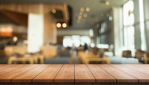 istock Empty wooden table top with lights bokeh on blur restaurant background. 2229678540