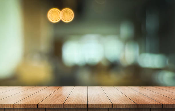 istock Empty wooden table top with lights bokeh on blur restaurant background. 2229678583