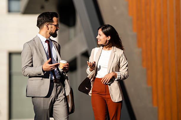 istock Business people talking and walking outside office building 2229678792