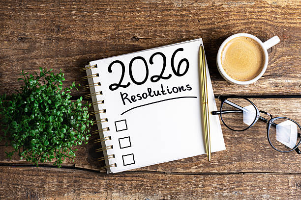 istock New year resolutions 2026 on desk. 2026 resolutions list with notebook, coffee cup on table. Goals, resolutions, plan, action, checklist concept. New Year 2026 template 2229679139
