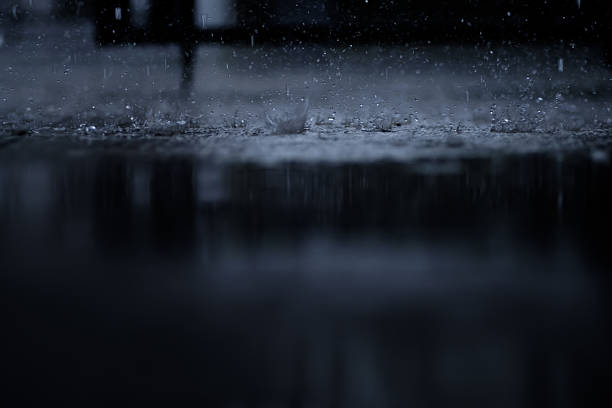 istock heavy raining make many small splash crown from water droplets drop down to the concrete floor in blue tone color scene 2229679418