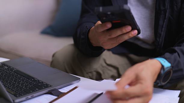 istock Convenient Home Finance – Asian Man Paying Bills Using Smartphone. 2229679648