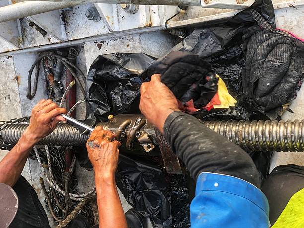 istock Technicians are repairing an air bridge mechanism, using tools to fix the large threaded shaft. They are working to maintain airport equipment, ensuring smooth operations 2229680949
