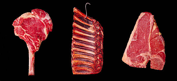 istock Different cuts of raw beef arranged against a black background 2229681670