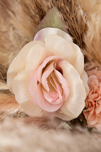 istock Delicate artificial rose in soft cream and blush pink tones, surrounded by beige pampas grass and other fabric flowers and decor 2229682115