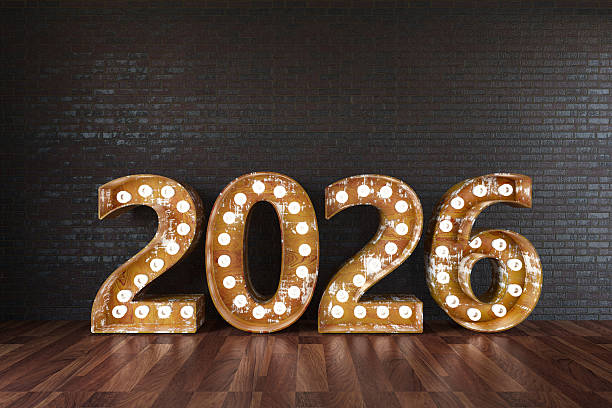 istock 2026 Light Bulb Sign Against Black Wall 2229682328