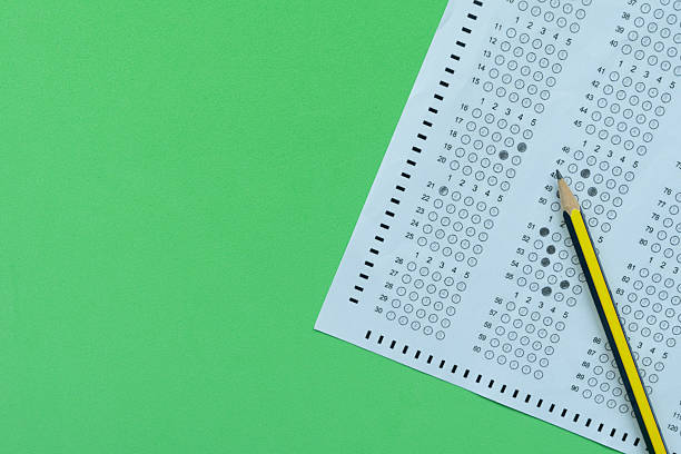 istock close up pencil on answer sheets with green background, education concept 2229682615