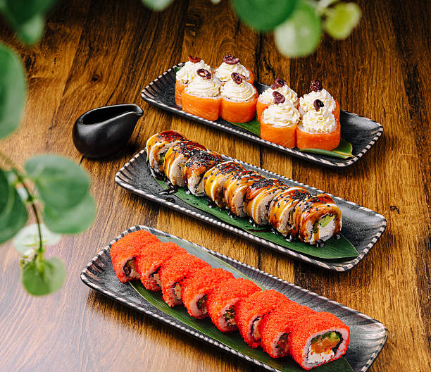 istock Artfully arranged sushi rolls on wooden table in Japanese restaurant setting 2229682809
