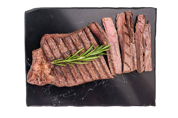 istock Grilled medium beef Rump steak on marble board isolated on white background 2229683171