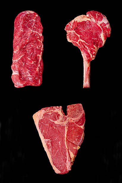 istock Different cuts of raw meat displayed creatively on black background 2229683430